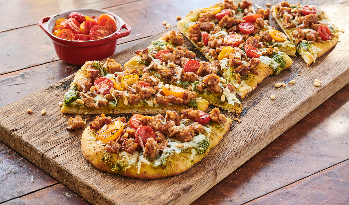 pizza featuring Hillshire Farm® All Natural* Fully Cooked Italian Sausage on table