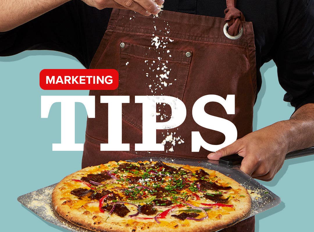 Person holding a pizza