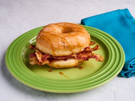 Apple Fritter Bacon Bliss Breakfast Sandwich with bacon, apple cider and brown sugar on an apple fritter