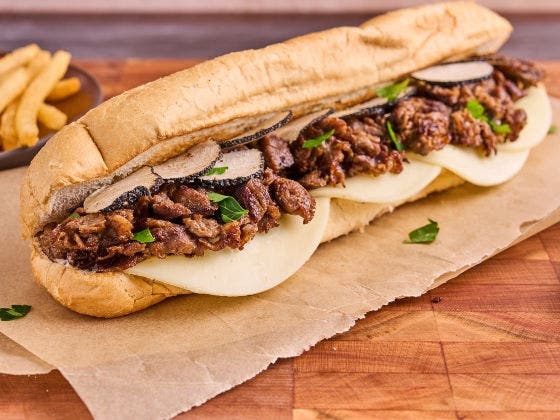 Shaved steak, truffle aioli, provolone cheese, and shaved black truffles served on a hoagie bun.
