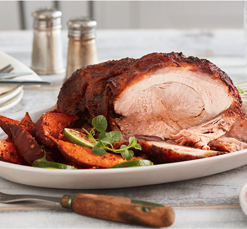 Sliced pork butt with a side of sweet potatoes