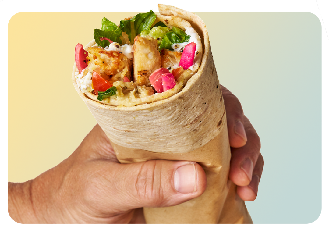 Direct view of an open-ended steak wrap with roasted peppers and herb chimichurri showing   