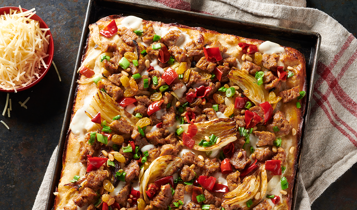 pizza featuring Hillshire Farm® All Natural* Fully Cooked Spicy Italian Sausage on table