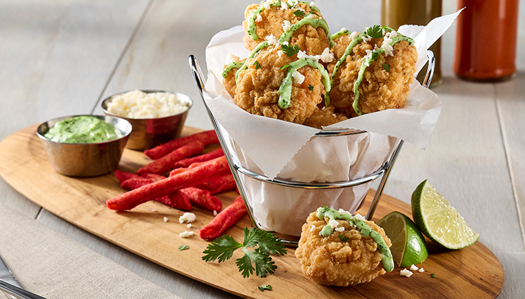 chicken with a side of fries and two sides of sauces