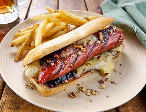 Grilled Hillshire Farm smoked sausage hoagie with cranberry-currant chutney, melted brie, and crushed walnuts on toasted brioche bun