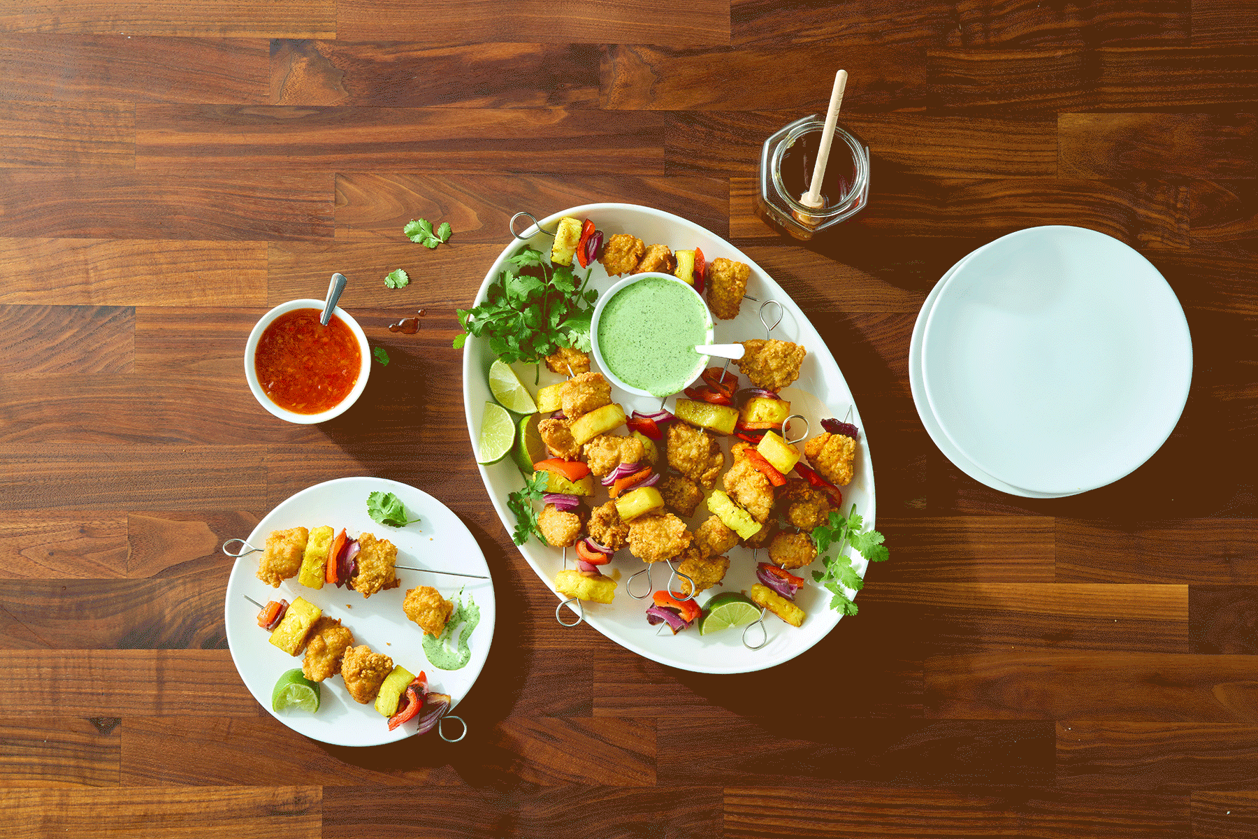 Overhead shot of skewer dish made with Tyson® Honey Stung® Fully Cooked Lightly Breaded Original Honey Chicken Breast Chunks