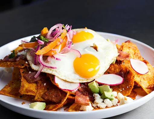 Applewood Smoked Bacon Chilaquiles on a plate with eggs