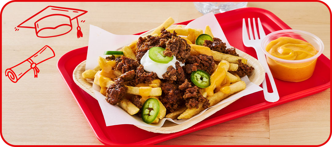 Fries topped with jalapenos beef and sour cream with a side of nacho cheese