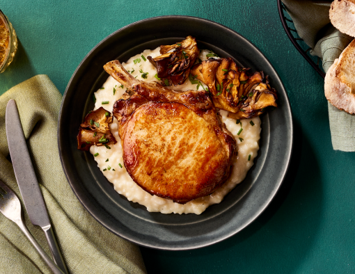 Pan-seared Frenched pork chop steak with risotto and roasted maitake mushrooms