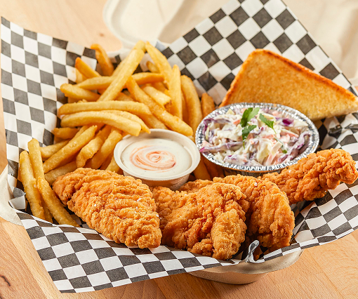 Chicken tenders in basket with Texas toast, slaw and fries