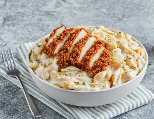 A crispy chicken Filet, sliced, on top of mac n cheese shells