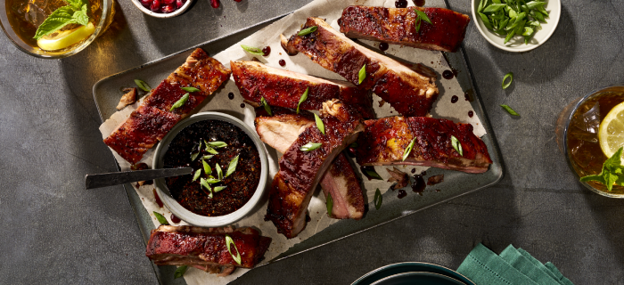 Rack of St. Louis-style pork ribs on wooden platter