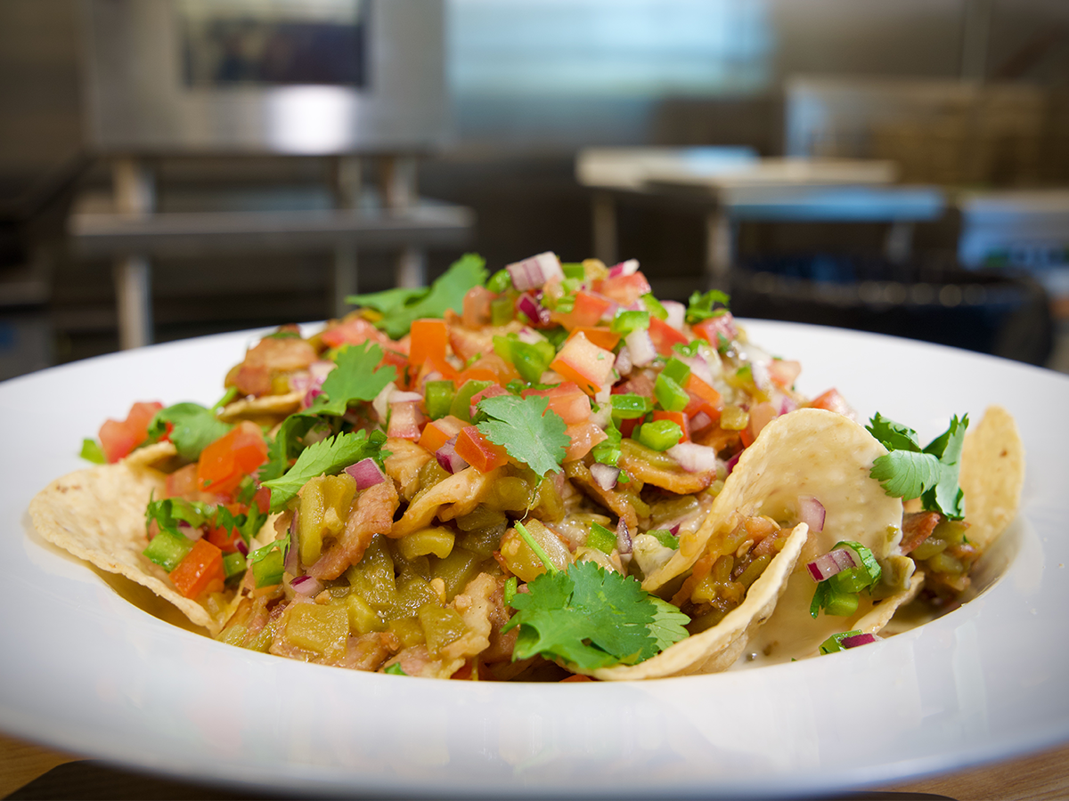 How to make the Hatch Green Chili Nachos with Mexican Original® Yellow Corn Round Salted Tortilla Chips and Hillshire Farm® Fully Cooked Sliced Pork Belly.