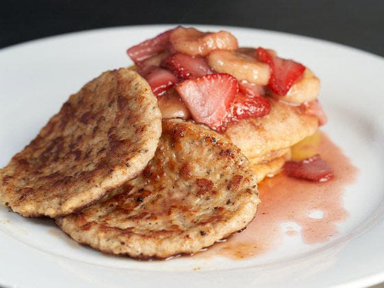 Johnny Cakes With Sausage and Strawberries on a Plate.