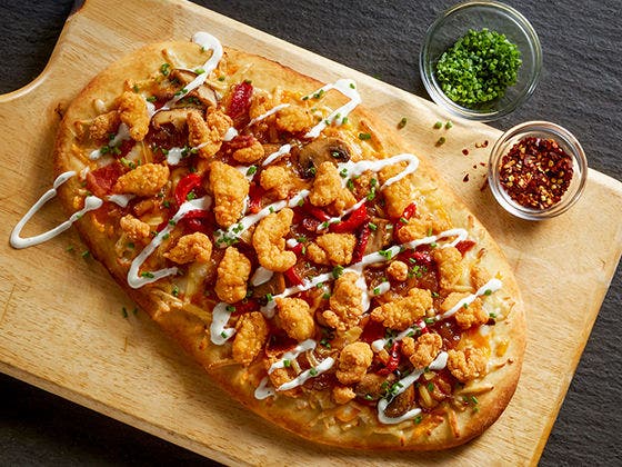 Tyson® Mini Chicken Bites served on a sweet and savory Chicken Bacon and Ranch Flatbread.