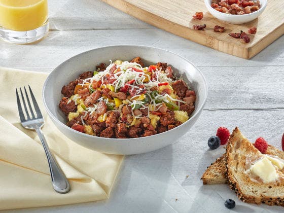  Southwest Sunrise Bowl with pork chorizo crumbles, scrambled eggs, crispy bacon, roasted peppers, tomatoes and Monterey Jack cheese