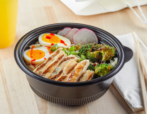 Chicken Breast Strips are placed in a bowl filled with a rich broth and tender noodles, all topped with a halved boiled egg