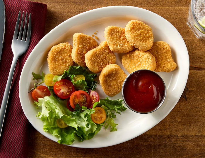 Gliten free nuggets with a side out sauce and salad
