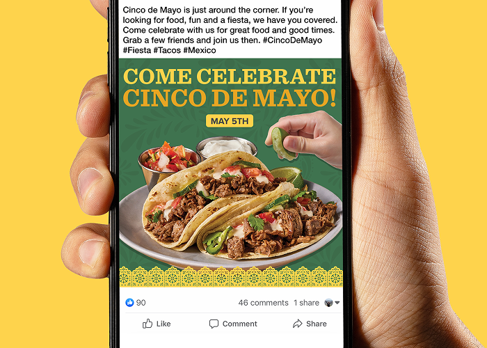 A hand holding a phone with a social post promoting Cinco de Mayo