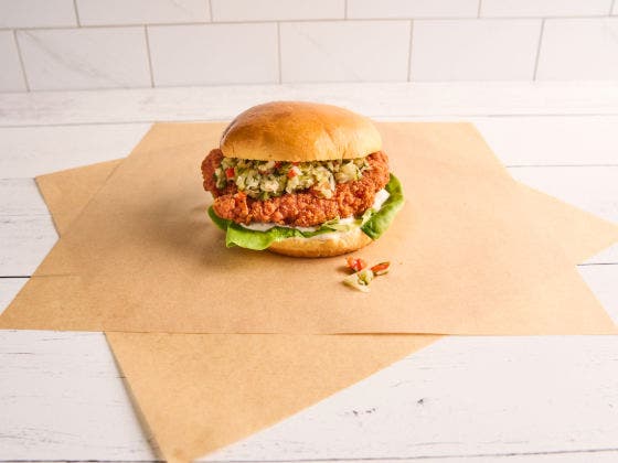 Crispy fried chicken sandwich on a brioche bun with lettuce, pickle ranch, and pickle de gallo