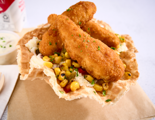 Breaded chicken tenders served on bed of mashed potatoes drizzled with dill pickle ranch dressing in a waffle cone bowl 