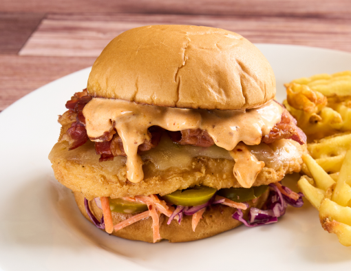 Chicken Bacon Chili Crunch Ranch Sandwich on a plate with a side of fries.