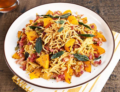 Fideo pasta with velvety butternut squash carbonara sauce topped with crispy Hillshire Farm Bakin' Bacon, toasted pepitas, and fried sage leaves