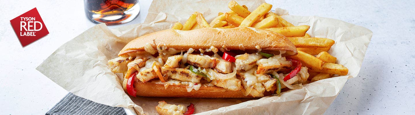 Tyson Red Label versatile ingredient chicken inside of a sandwich with french fries