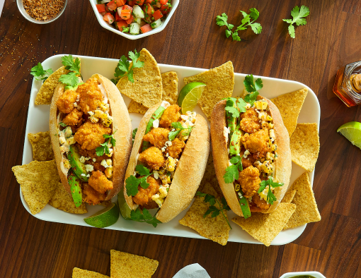 Hot Honey Chicken Elote Torta served with chips and dip