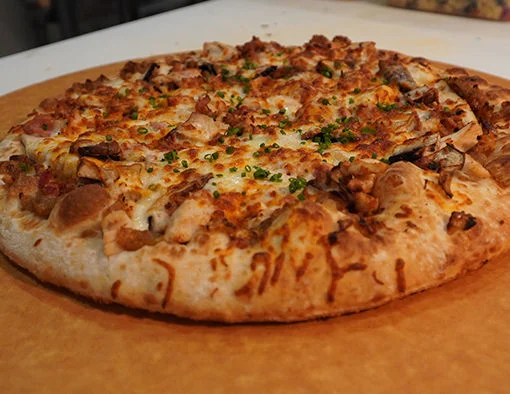 Wood Fire Seasoned Chicken, chopped bacon, roasted mushrooms, caramelized onion jam, with a trio of cheese, smoked gouda, aged cheddar and mozzarella cheese
