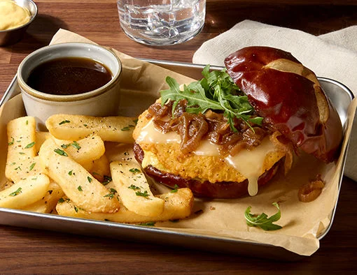 Crispy chicken breast with caramelized onions, Gruyere cheese, arugula on pretzel roll, side of steak fries