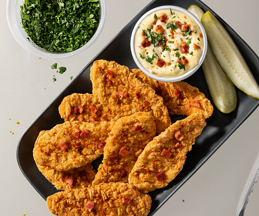 Chicken tenders with crumbles, dipping sauce and pickles
