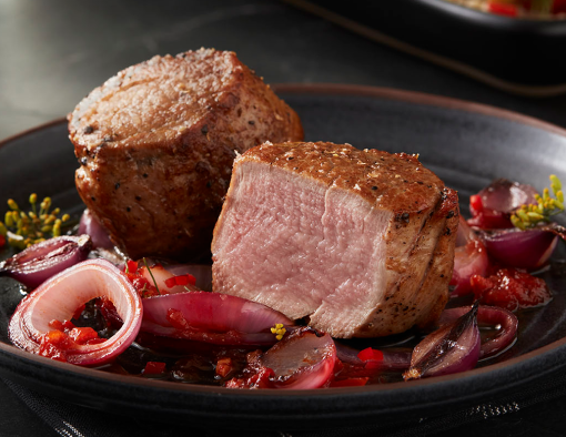 Seared Medallions With Onions in a plate