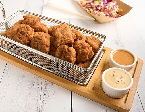 Spicy breaded beef bites served with maple mustard dip, beer cheese sauce and broccoli slaw on the side