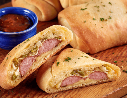 Kolaches have a light dough filled with sausage, cheese, and a mix of roasted mild green chile and onion