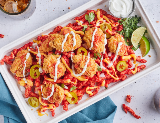 Loaded Spicy Cheesy Boneless Wings served with a side of hot chips