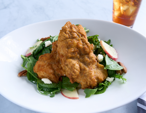 Honey Chicken Tenderloins on a bed of crisp arugula and spinach with toasted pecans