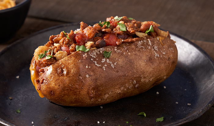 sandwich featuring Original Philly® Fully Cooked Seasoned Sliced Beef with Peppers and Onions in restaurant setting