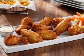 Chicken wings with sauce and fries