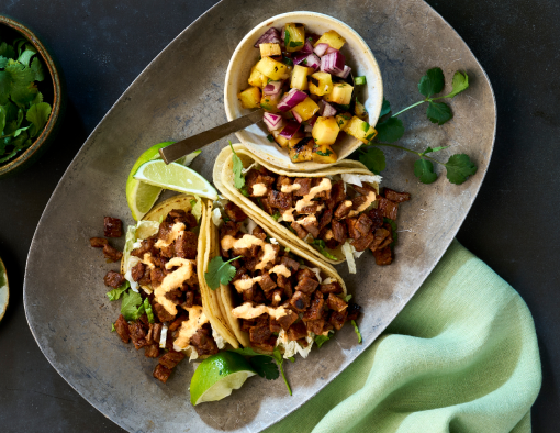 Bulgogi marinated sliced beef chuck roll on warm street taco tortillas