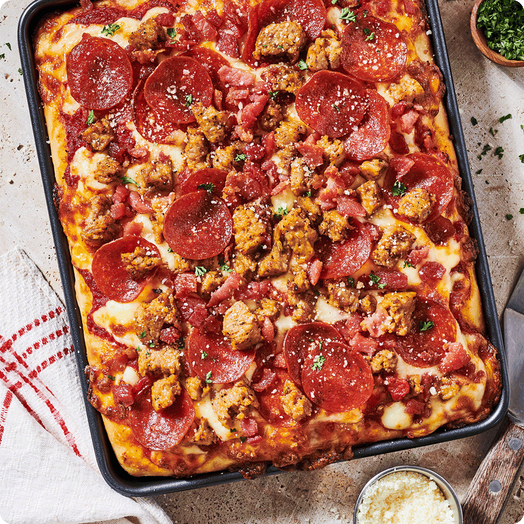 Deep dish pizza topped with pepperoni and sausage
