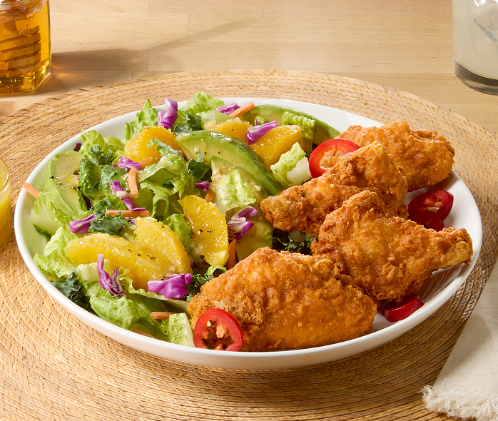 Tyson® Honey Stung® Fully Cooked Lightly Breaded Hot Honey Bone-In Chicken Wing Sections, Jumbo, on plate 