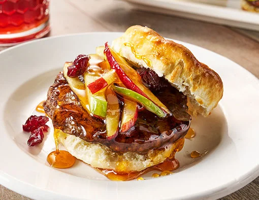 Hot honey-glazed Jimmy Dean sausage patty topped with apple cranberry slaw on a buttermilk biscuit