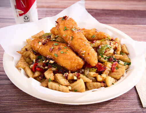 Breaded chicken tenders over small waffle bites topped with roasted peppers and onions in garlic honey served on paper plate