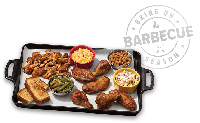 Tray of Tyson® Pitmaster Chicken Wings and Thigh Pieces, plus beans, macaroni and cheese, toasts and more sides