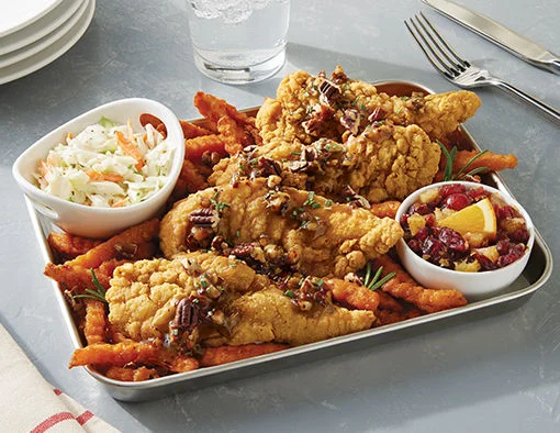 Chicken Tenderloins topped with sweet-and-savory honey pecan sauce, served on a bed of crinkle-cut sweet potato fries