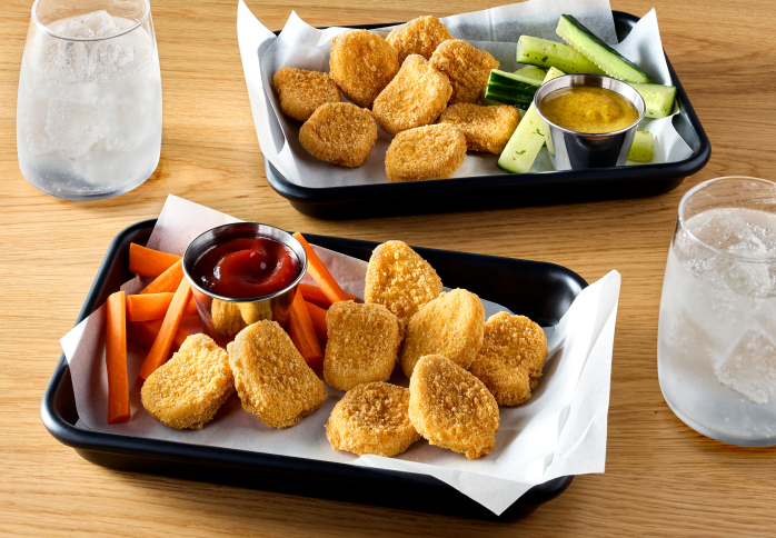two trays, each with chicken nuggets on it