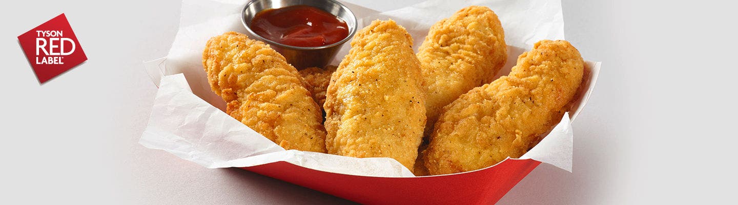 Basket of crispy chicken tenders with ketchup