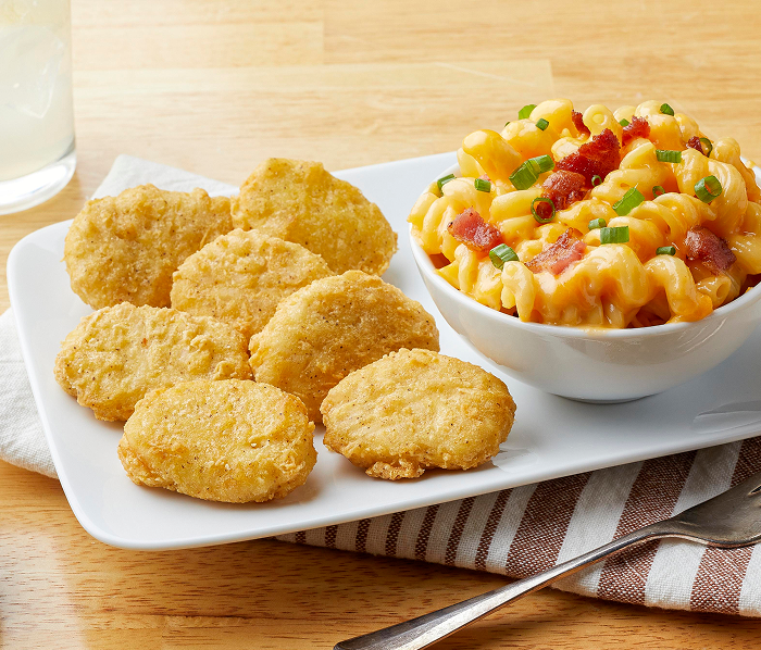 chicken breast nuggets, sauce and a beverage