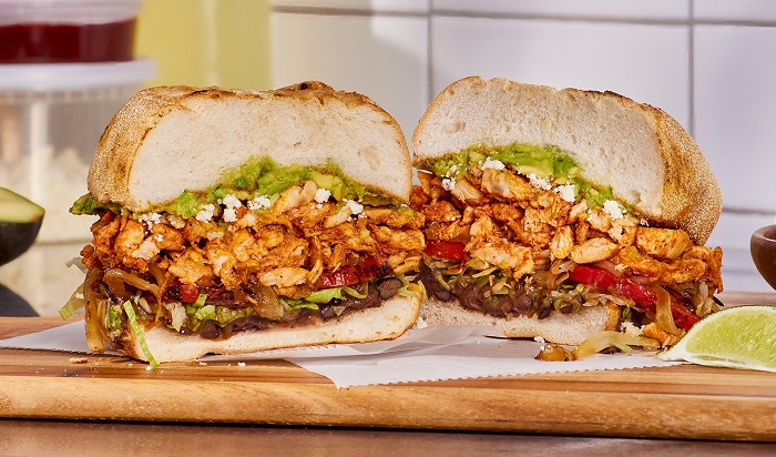 sandwich featuring Original Philly® Fully Cooked Seasoned Sliced Chicken in restaurant setting